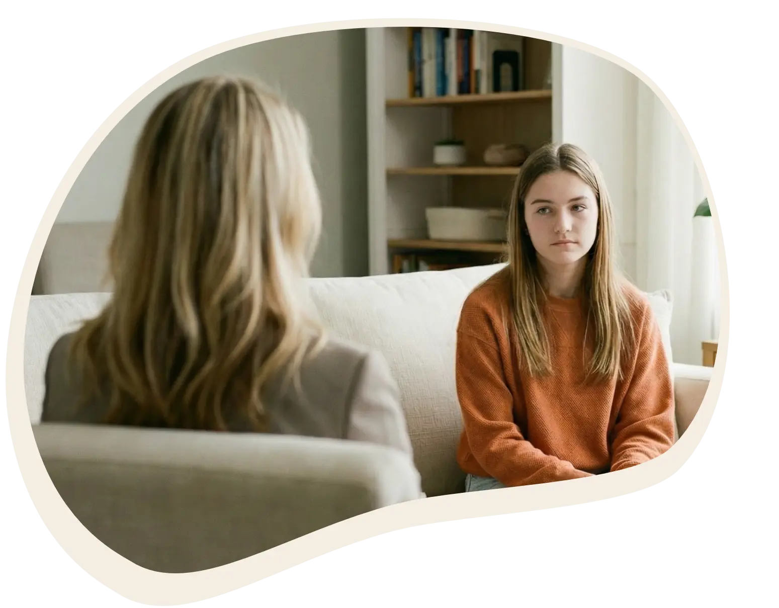 Mother father and teenage daughter in a therapy session sitting on a sofa